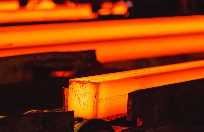 Close-up of steel production and a hot glowing piece of steel.