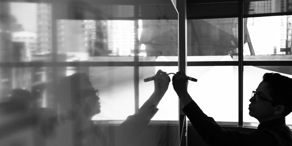 person-writing-on-whiteboard