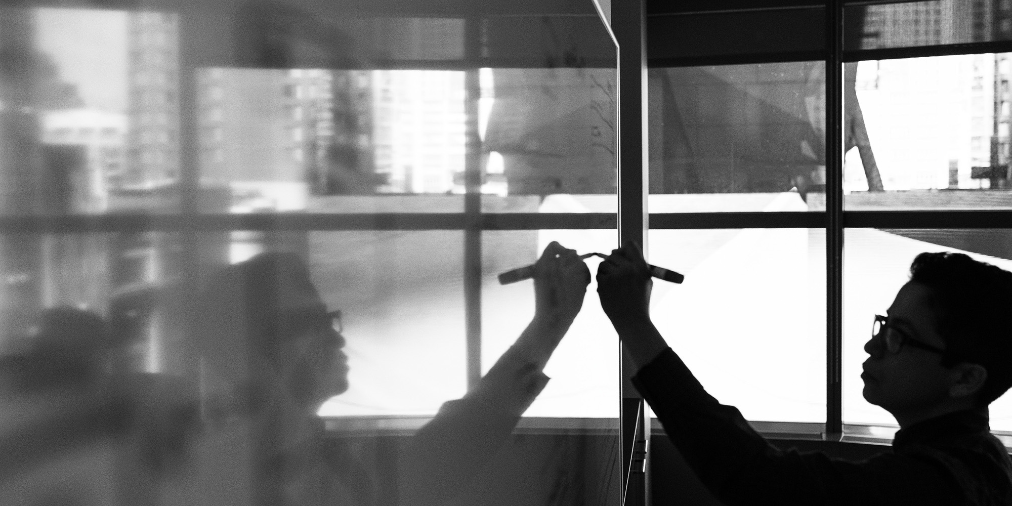 person-writing-on-whiteboard